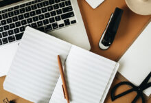 Home office desk workspace with laptop on ginger background. Flat lay, top view girl boss work business concept.